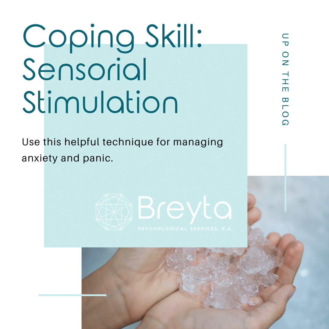 Hands hold ice to cope with anxiety as a CBT coping skill taught by a psychologist.