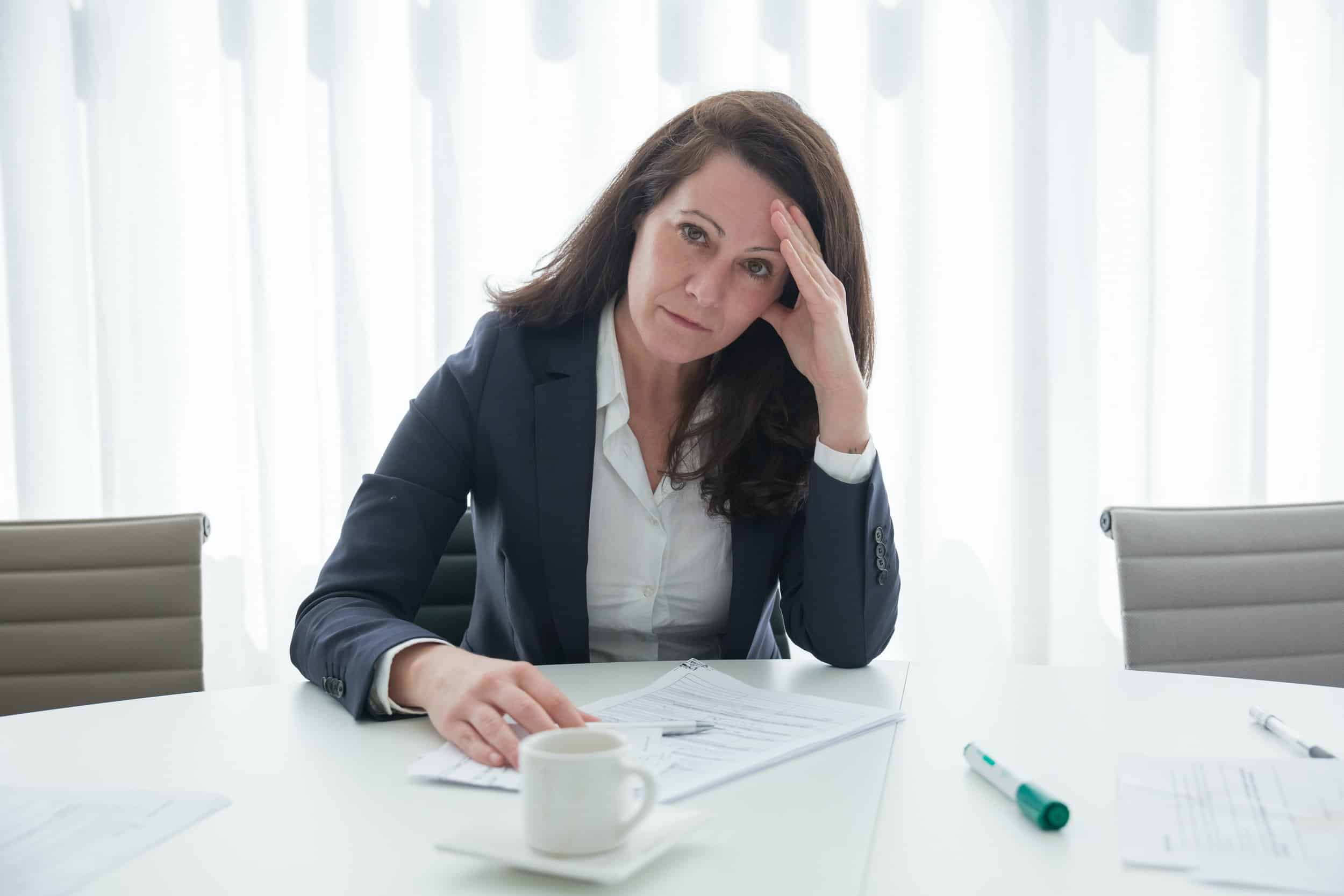 A professional woman is stressed at work and suffering from burnout.